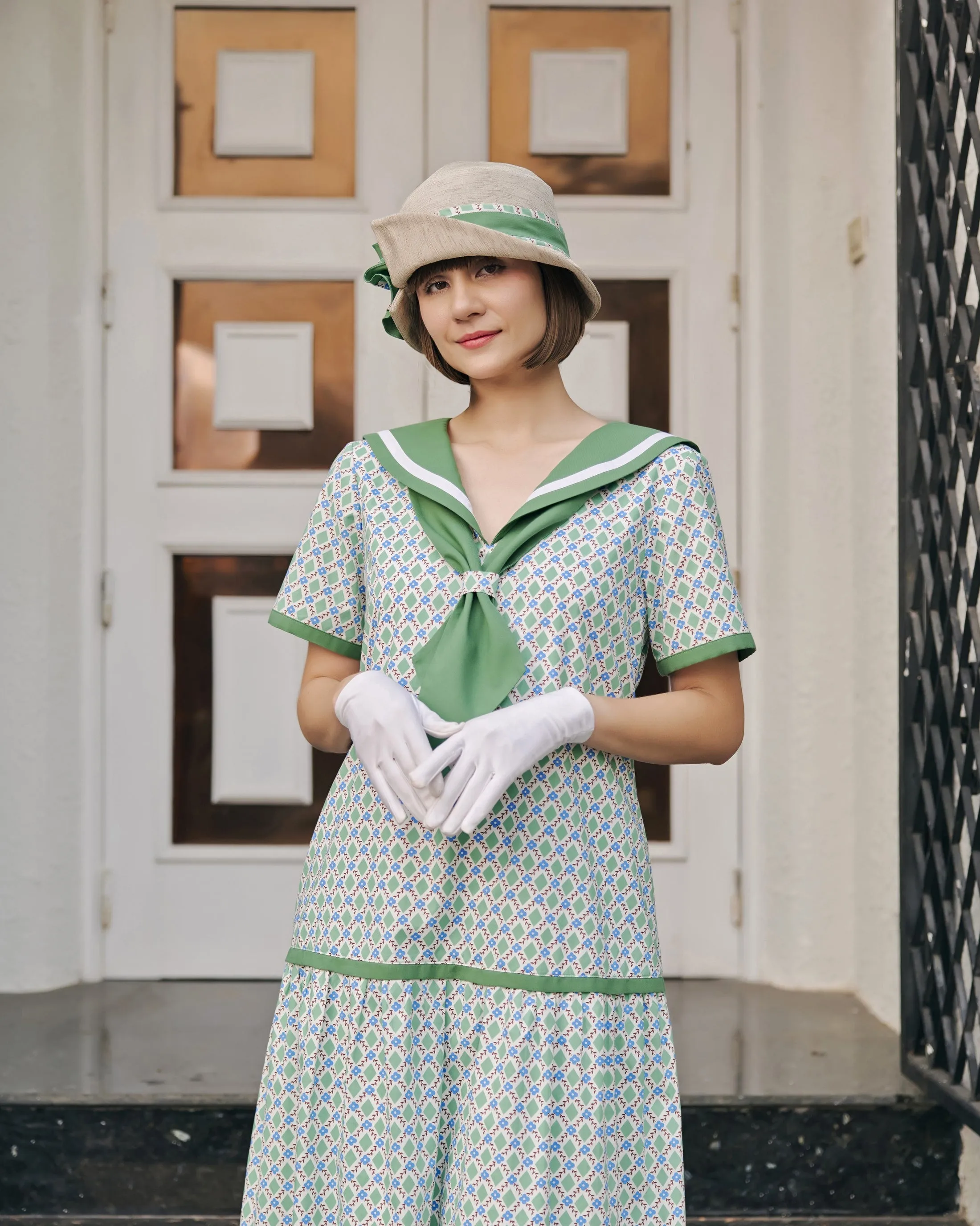 Cream cloche hat with green and white bow