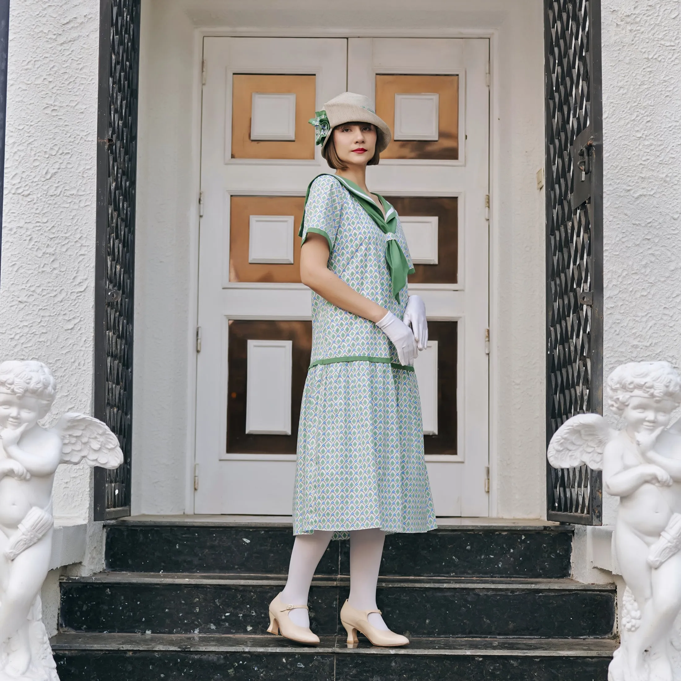 Cream cloche hat with green and white bow