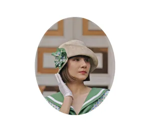 Cream cloche hat with green and white bow