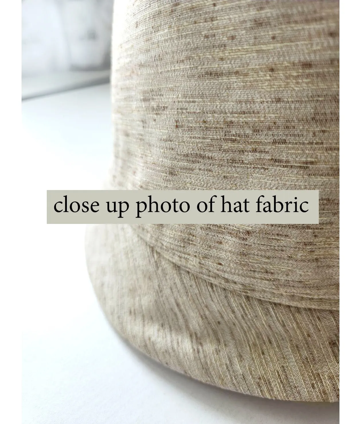 Cream cloche hat with green and white bow