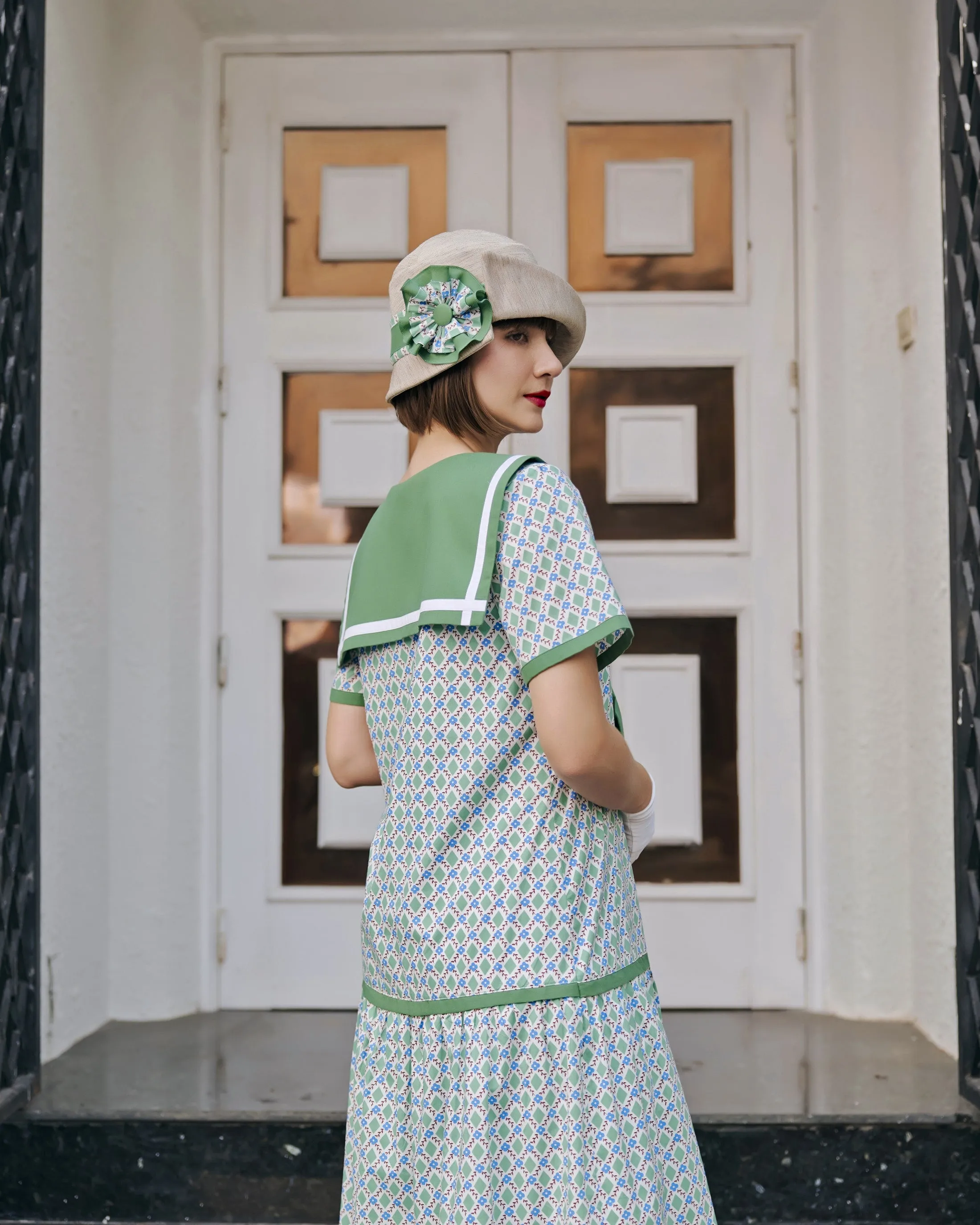 Cream cloche hat with green and white bow